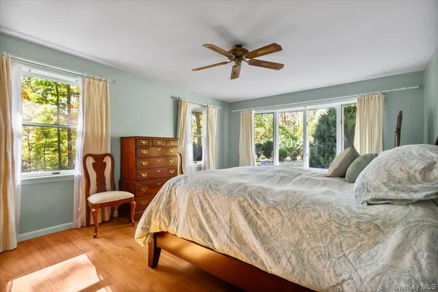 a bed sitting in a bedroom next to a window
