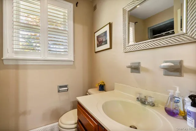a white toilet sitting next to a bathroom sink