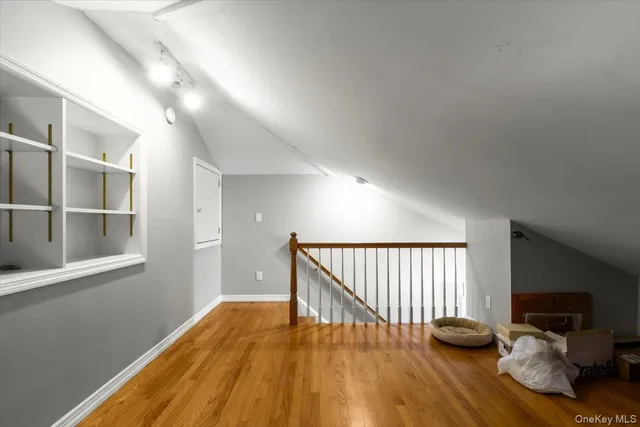 a view of a livingroom with wooden floor and a window