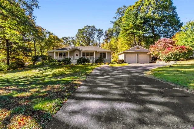 a front view of house with yard outdoor seating and green space