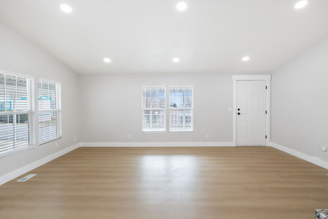 332 Hillgate Way Layton, UT 84041 - Photo 5 of 26 Unfurnished room with light wood-type flooring, healthy amount of natural light, recessed lighting, and lofted ceiling