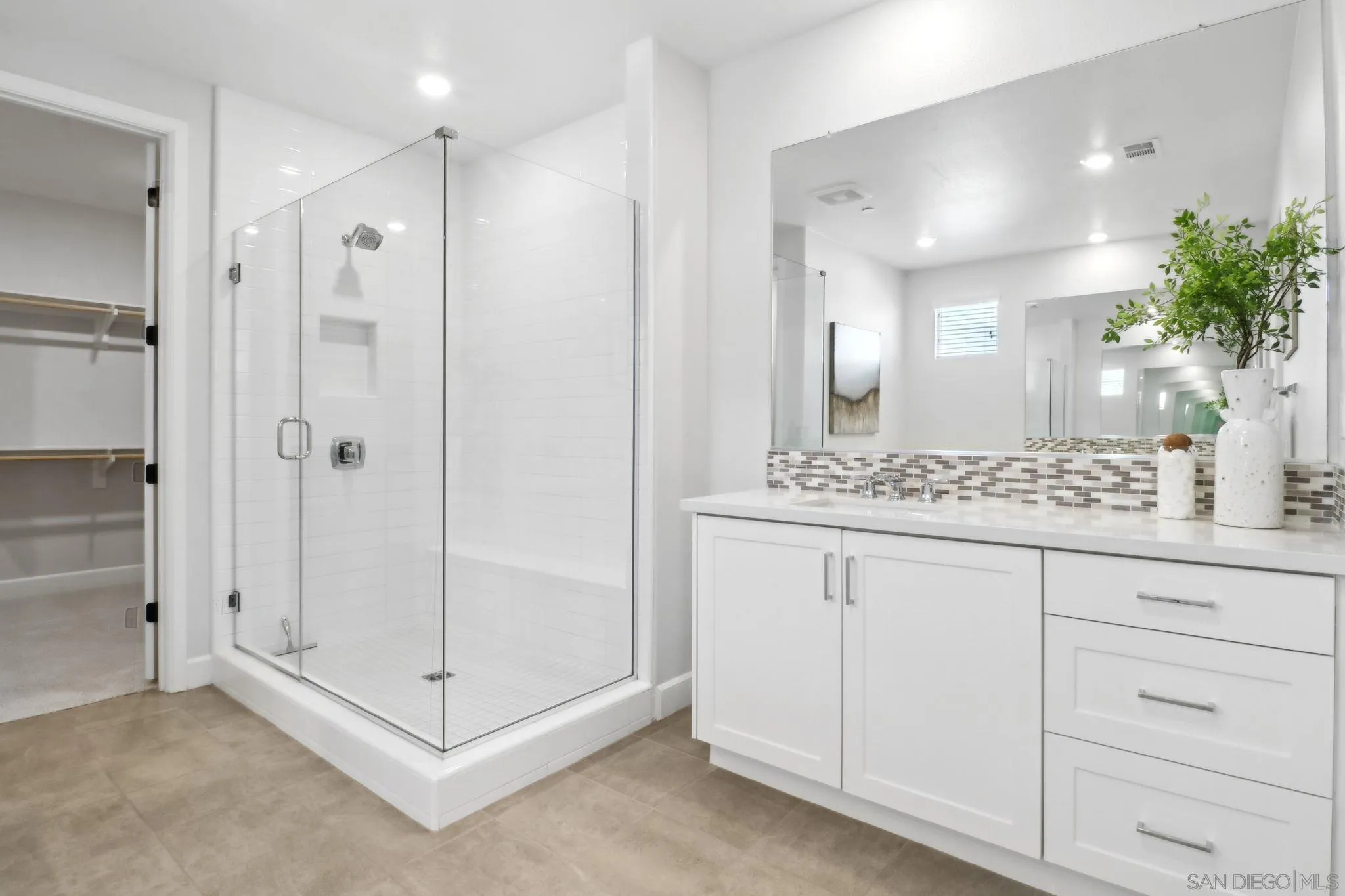 941 Lindbergh Drive San Marcos, CA 92069 - Photo 24 of 44 a bathroom with a shower sink and mirror