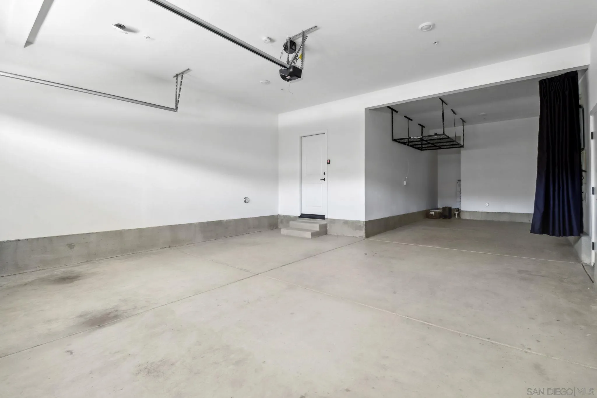 941 Lindbergh Drive San Marcos, CA 92069 - Photo 34 of 44 an empty room with stairs and a ceiling fan