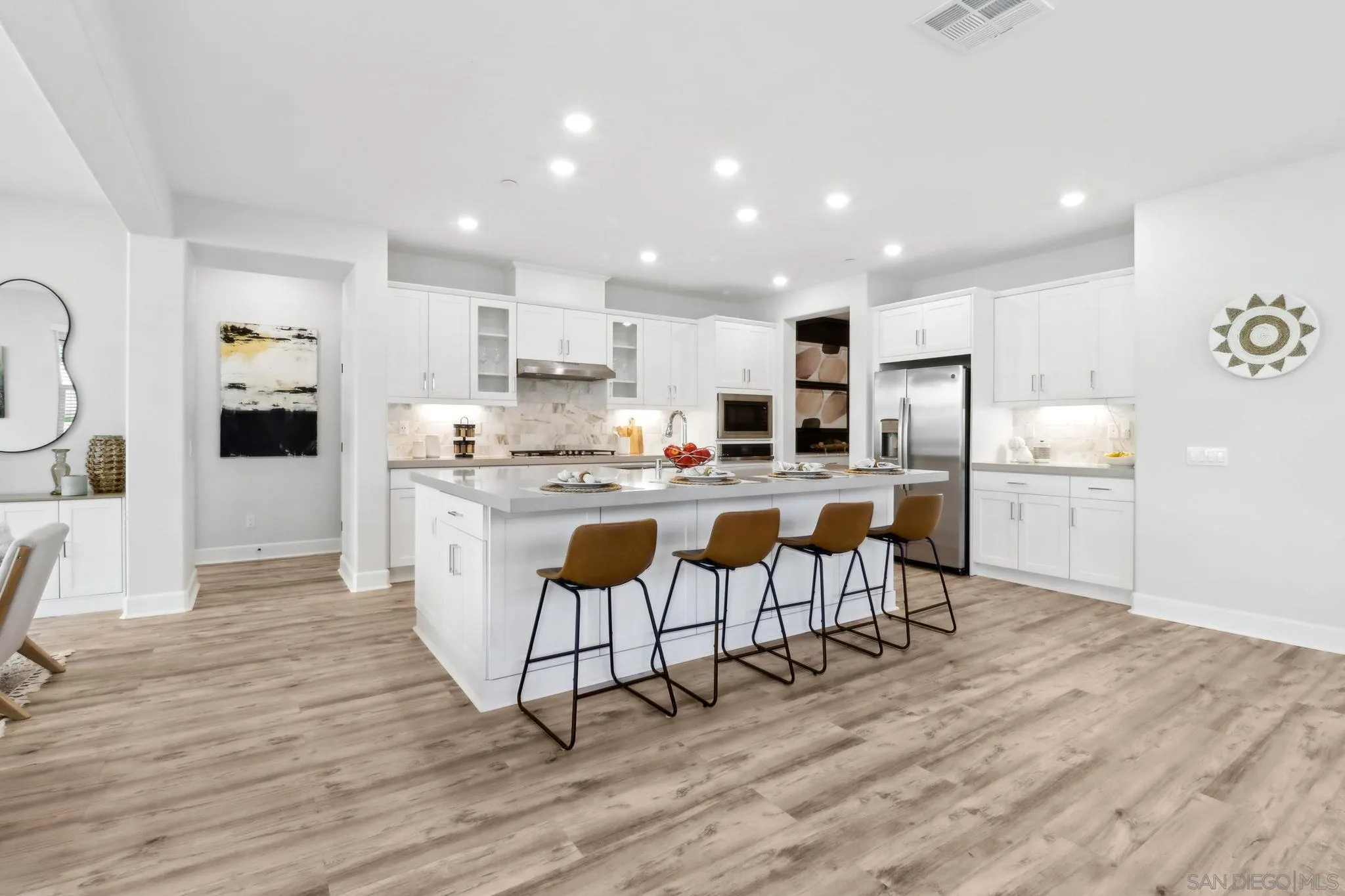 941 Lindbergh Drive San Marcos, CA 92069 - Photo 4 of 44 a kitchen with stainless steel appliances kitchen island granite countertop a refrigerator and a stove top oven
