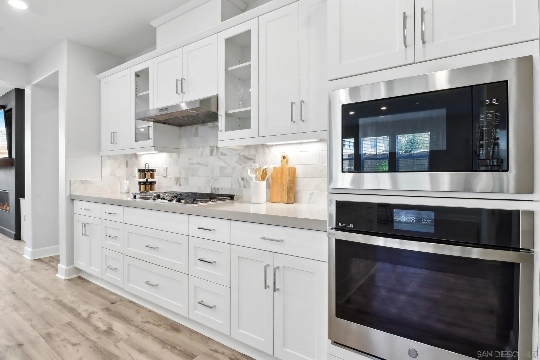 941 Lindbergh Drive San Marcos, CA 92069 - Photo 6 of 44 a kitchen with stainless steel appliances granite countertop white cabinets and a stove