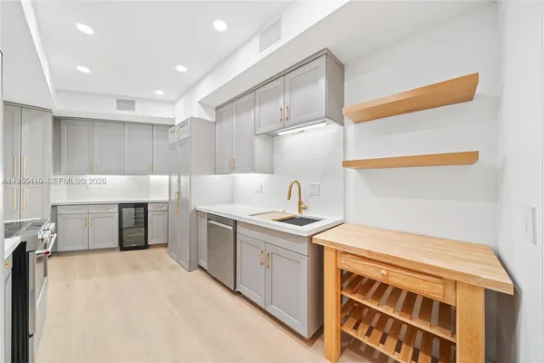 a kitchen with a sink stove and cabinets