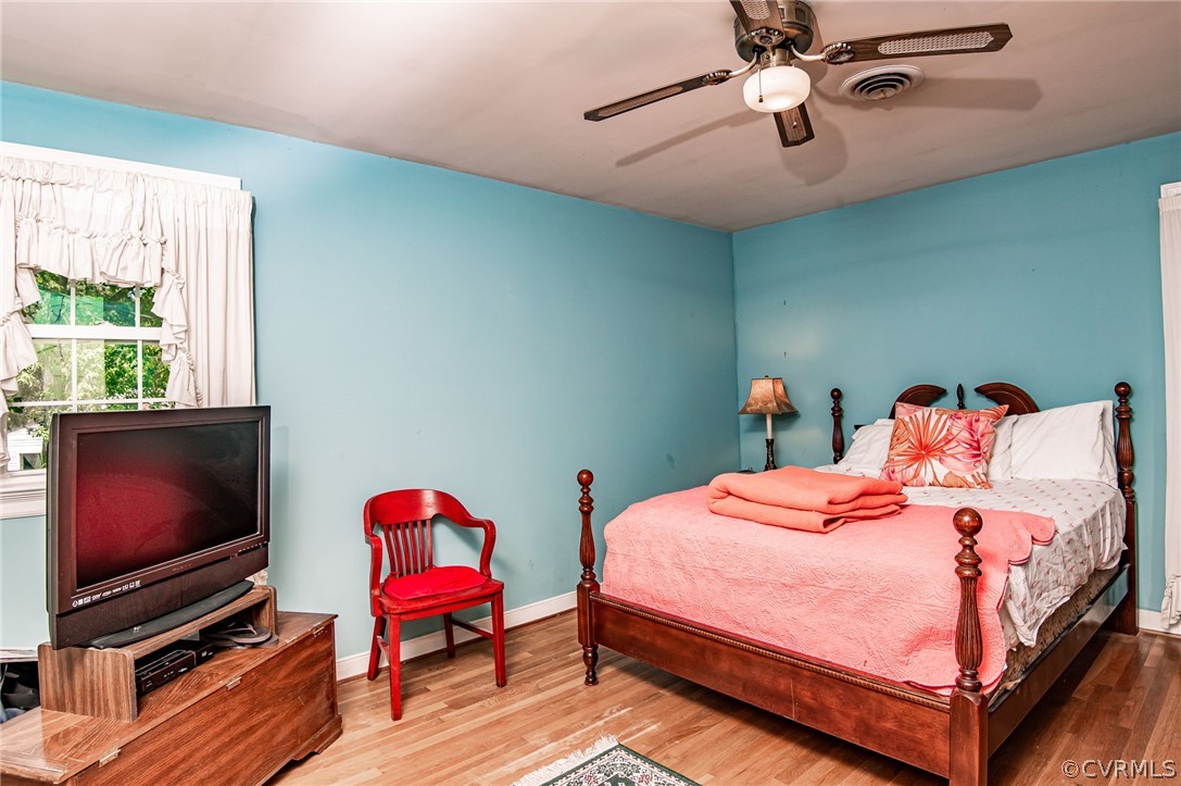 10960 Stepney Road Chester, VA 23831 - Photo 18 of 31 a bedroom with a bed and a flat screen tv