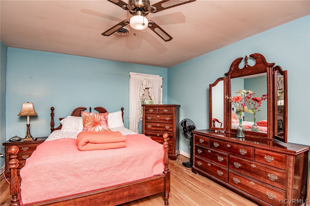 10960 Stepney Road Chester, VA 23831 - Photo 19 of 31 a bedroom with a bed and a flat screen tv