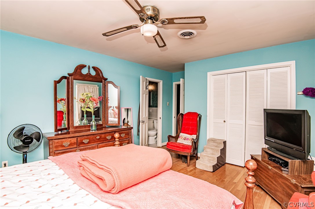 10960 Stepney Road Chester, VA 23831 - Photo 20 of 31 a bedroom with a bed desk and flat screen tv