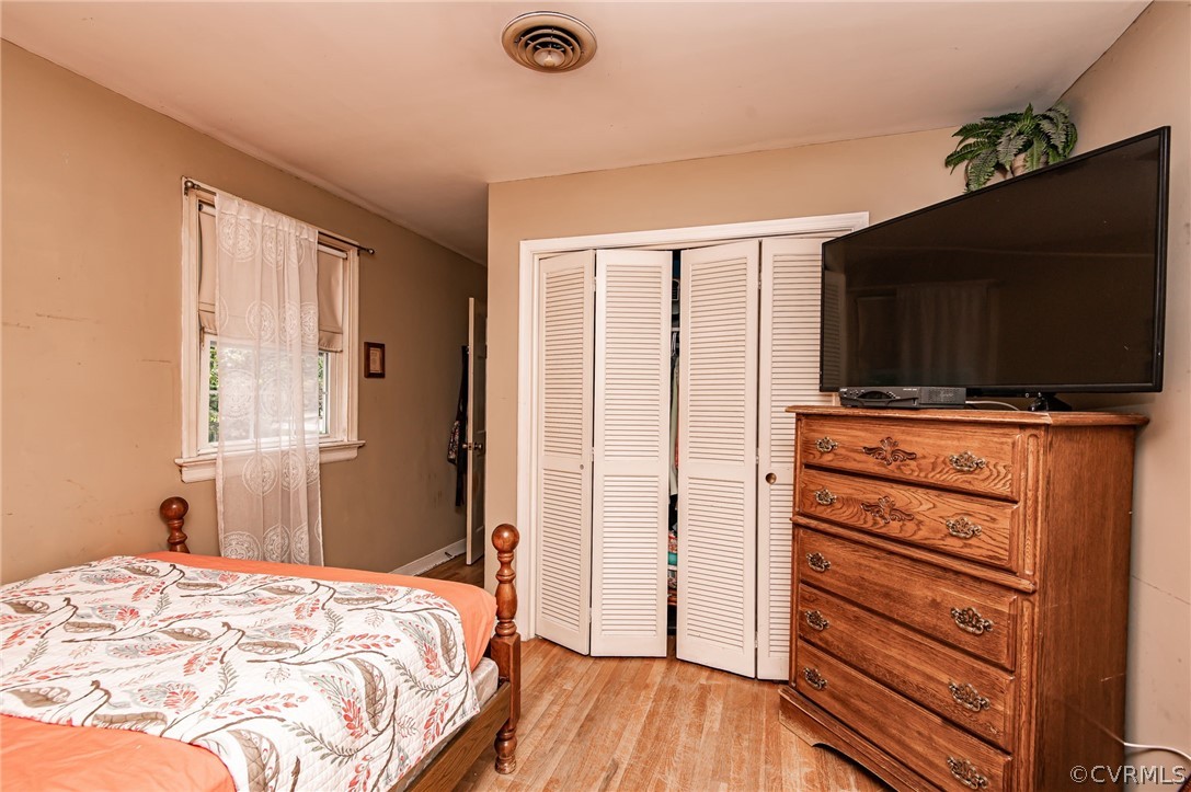 10960 Stepney Road Chester, VA 23831 - Photo 28 of 31 a bedroom with a bed and wooden floor