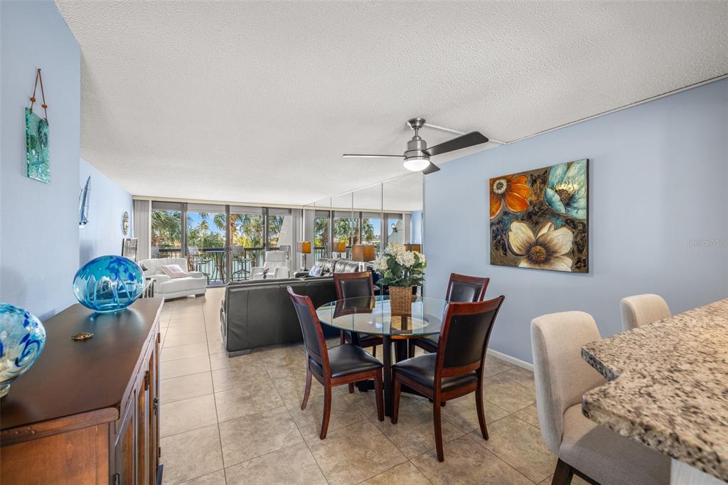 9495 Blind Pass Road, Unit 204 St. Pete Beach, FL 33706 - Photo 14 of 36 a dining room with furniture and window