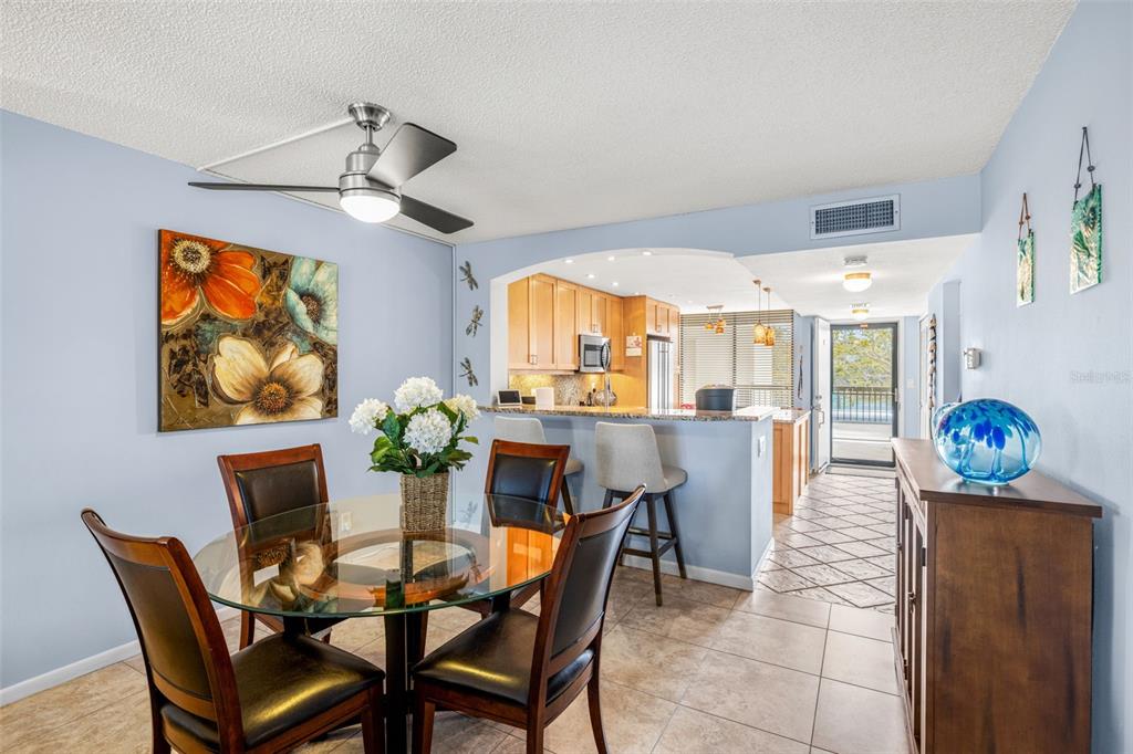 9495 Blind Pass Road, Unit 204 St. Pete Beach, FL 33706 - Photo 15 of 36 a dining room with furniture and window