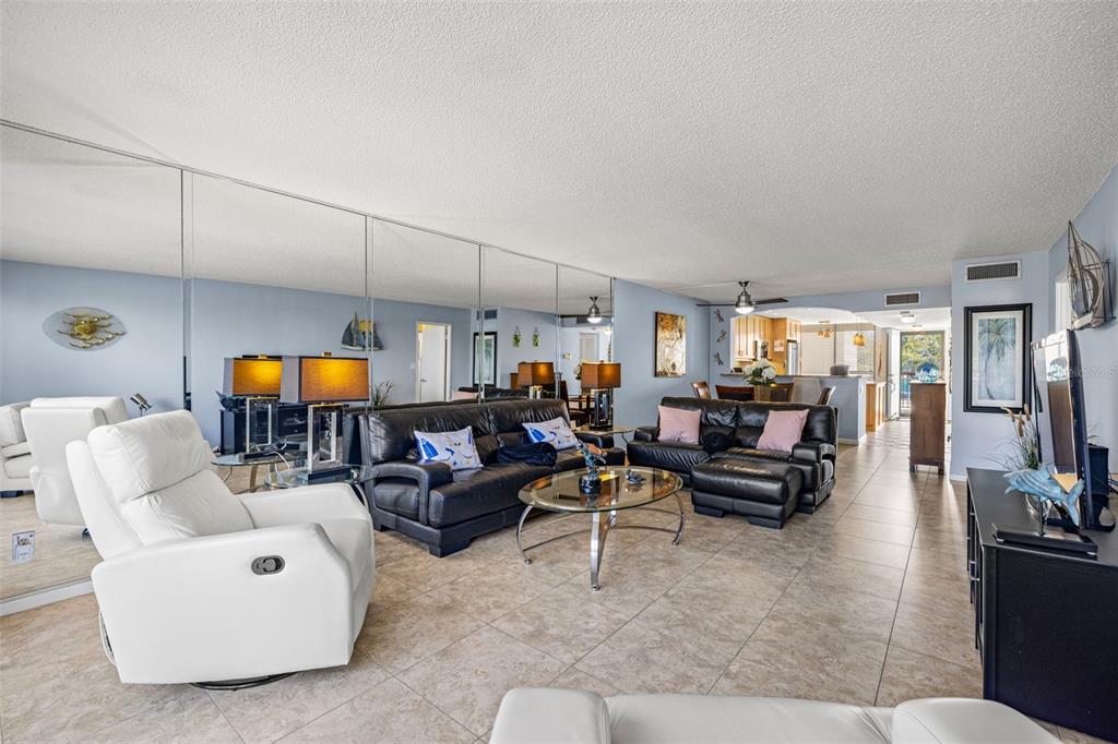 9495 Blind Pass Road, Unit 204 St. Pete Beach, FL 33706 - Photo 16 of 36 a living room with furniture and white walls