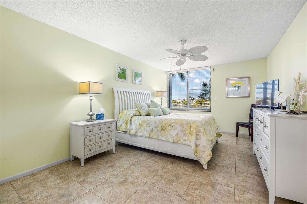 9495 Blind Pass Road, Unit 204 St. Pete Beach, FL 33706 - Photo 17 of 36 a bedroom with bed and window