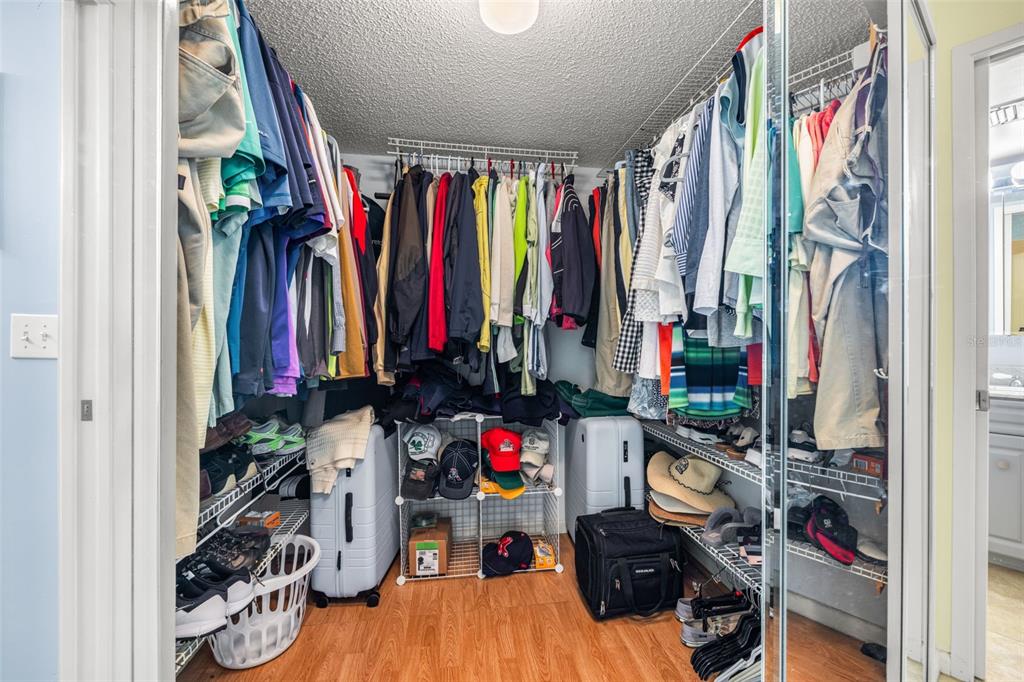 9495 Blind Pass Road, Unit 204 St. Pete Beach, FL 33706 - Photo 18 of 36 a view of walk in closet with clothes