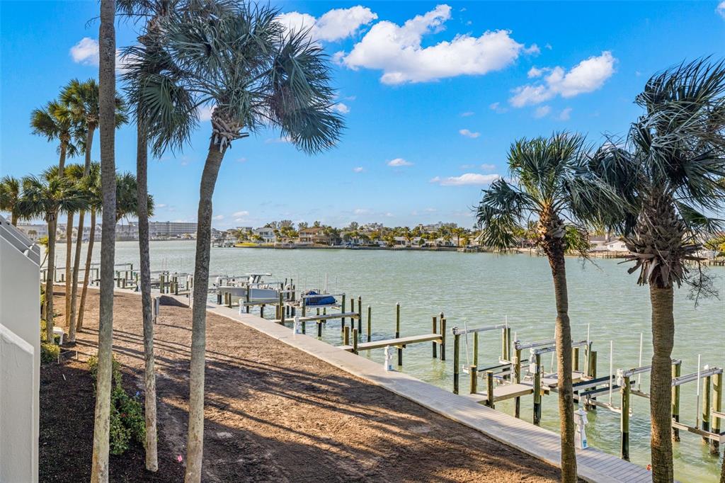 9495 Blind Pass Road, Unit 204 St. Pete Beach, FL 33706 - Photo 32 of 36 a view of a balcony with lake view and palm trees