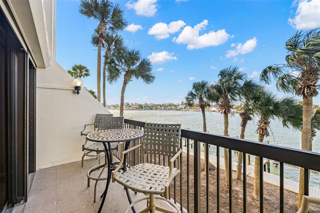 9495 Blind Pass Road, Unit 204 St. Pete Beach, FL 33706 - Photo 33 of 36 a view of a balcony with furniture