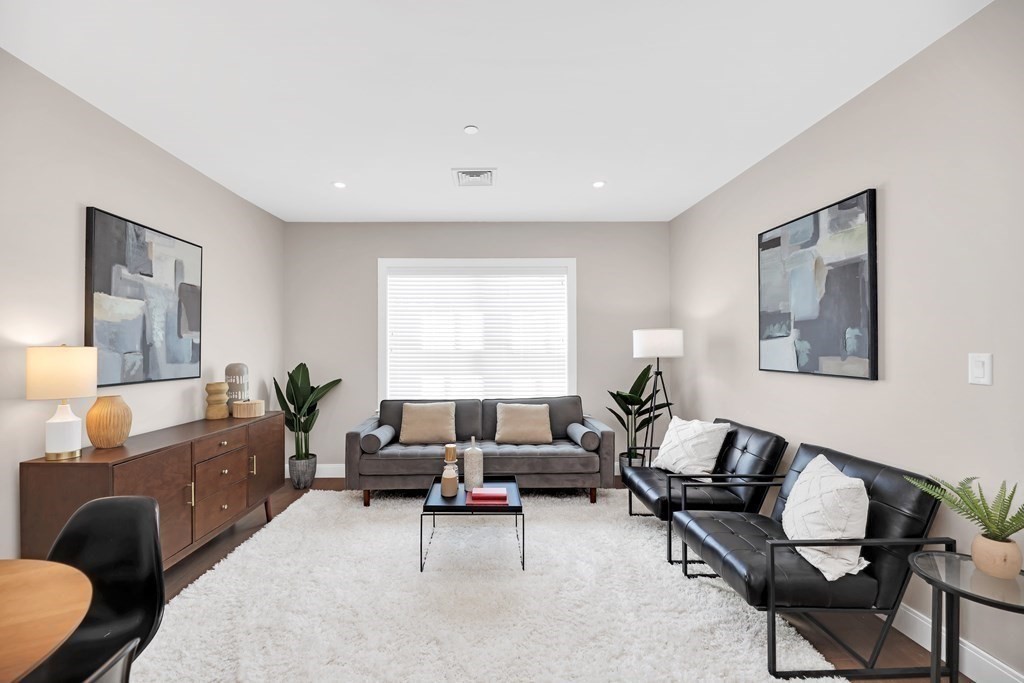 425 Lagrange Street, Unit 109 Boston, MA 02132 - Photo 14 of 42 a living room with furniture and a large window