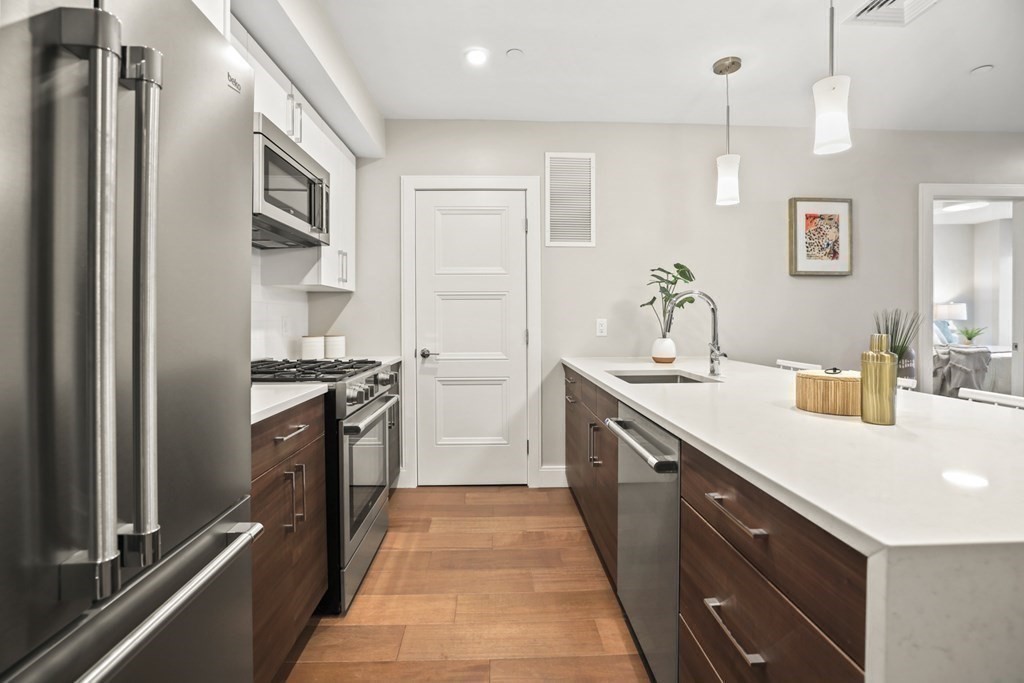 425 Lagrange Street, Unit 109 Boston, MA 02132 - Photo 15 of 42 a kitchen with a sink stove and refrigerator
