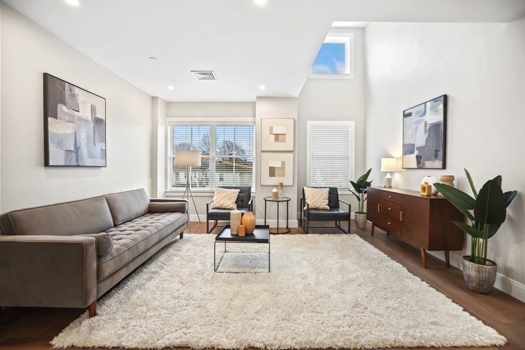 425 Lagrange Street, Unit 109 Boston, MA 02132 - Photo 16 of 42 a living room with furniture and a couch