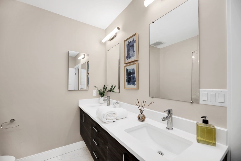 425 Lagrange Street, Unit 109 Boston, MA 02132 - Photo 18 of 42 a bathroom with 2 sink and a mirror