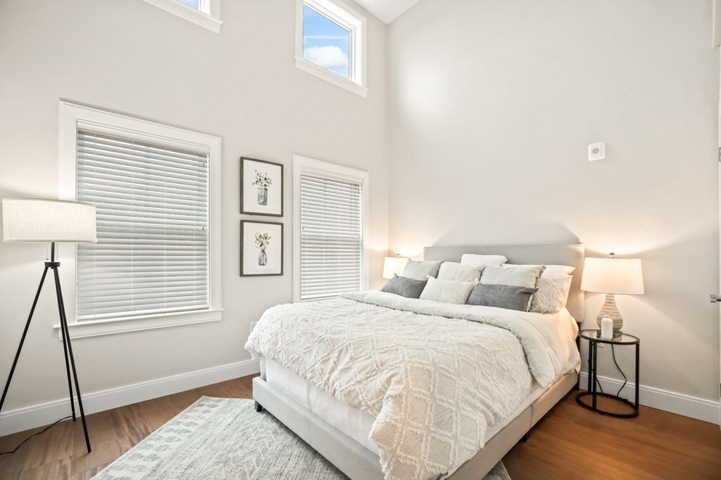425 Lagrange Street, Unit 109 Boston, MA 02132 - Photo 28 of 42 a bedroom with a bed and a window