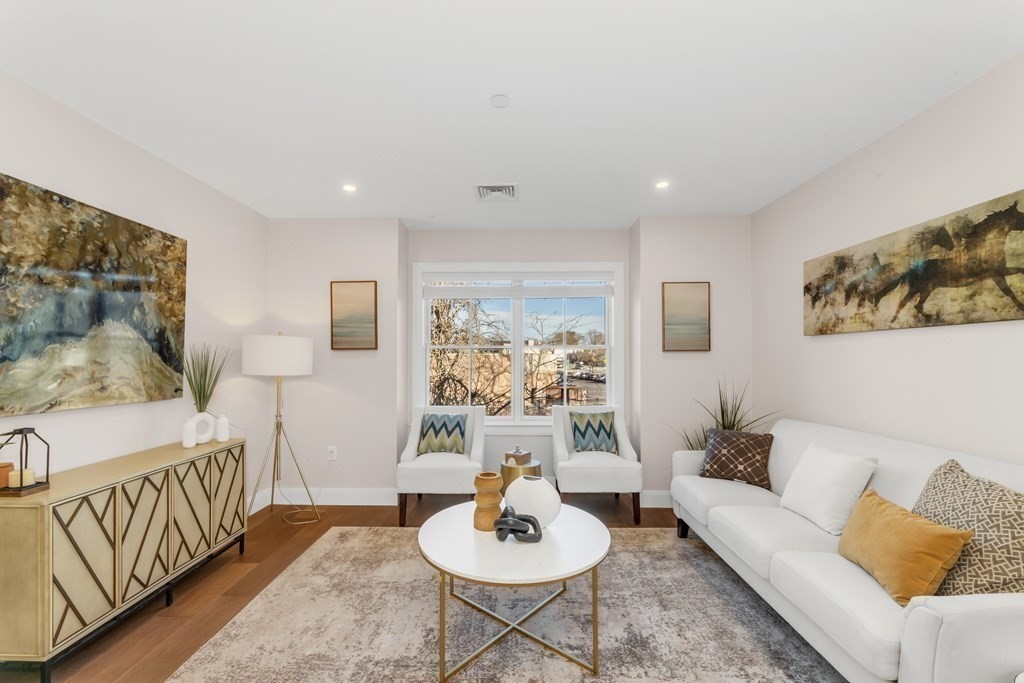 425 Lagrange Street, Unit 109 Boston, MA 02132 - Photo 3 of 42 a living room with furniture and a large window