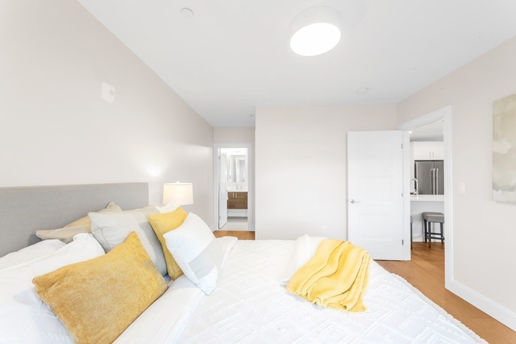 425 Lagrange Street, Unit 109 Boston, MA 02132 - Photo 10 of 42 a bedroom with a bed and a couch