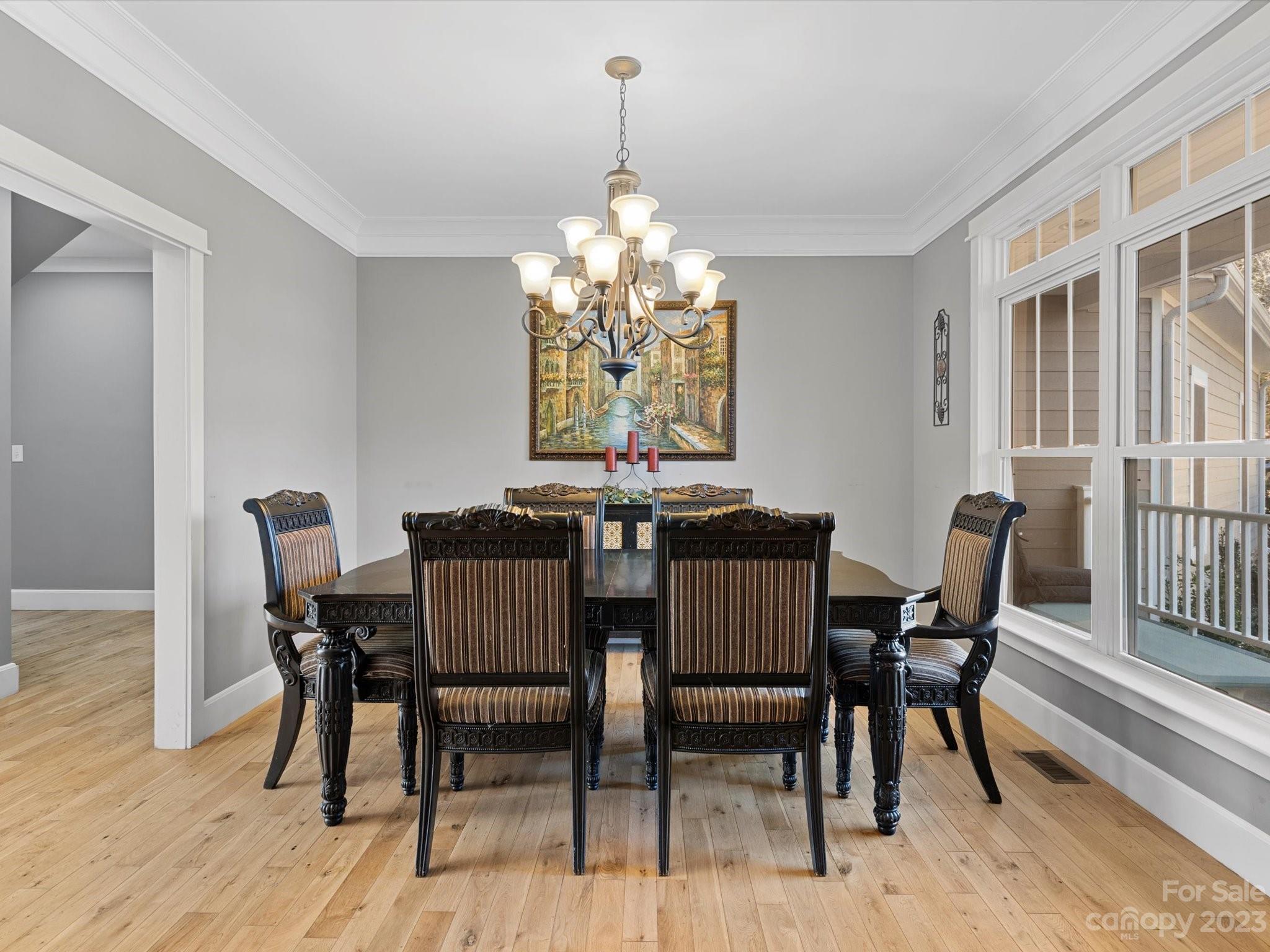 810 Sutton Spring Road York, SC 29745 - Photo 11 of 47 a dining room with furniture a chandelier and wooden floor