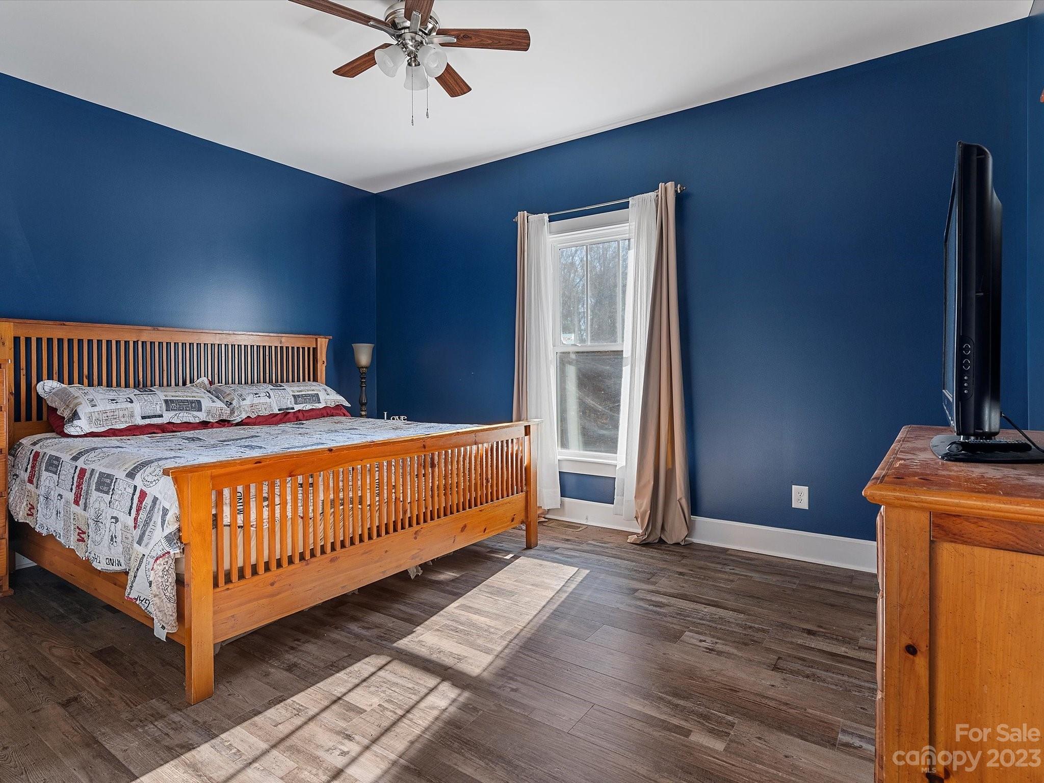 810 Sutton Spring Road York, SC 29745 - Photo 15 of 47 a bedroom with a bed and a chandelier
