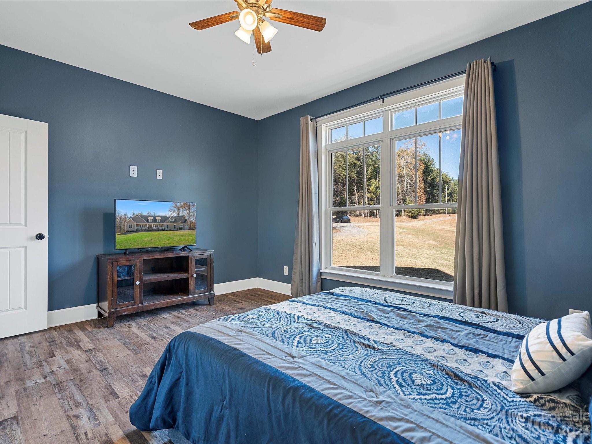 810 Sutton Spring Road York, SC 29745 - Photo 18 of 47 a bedroom with a bed and a flat screen tv