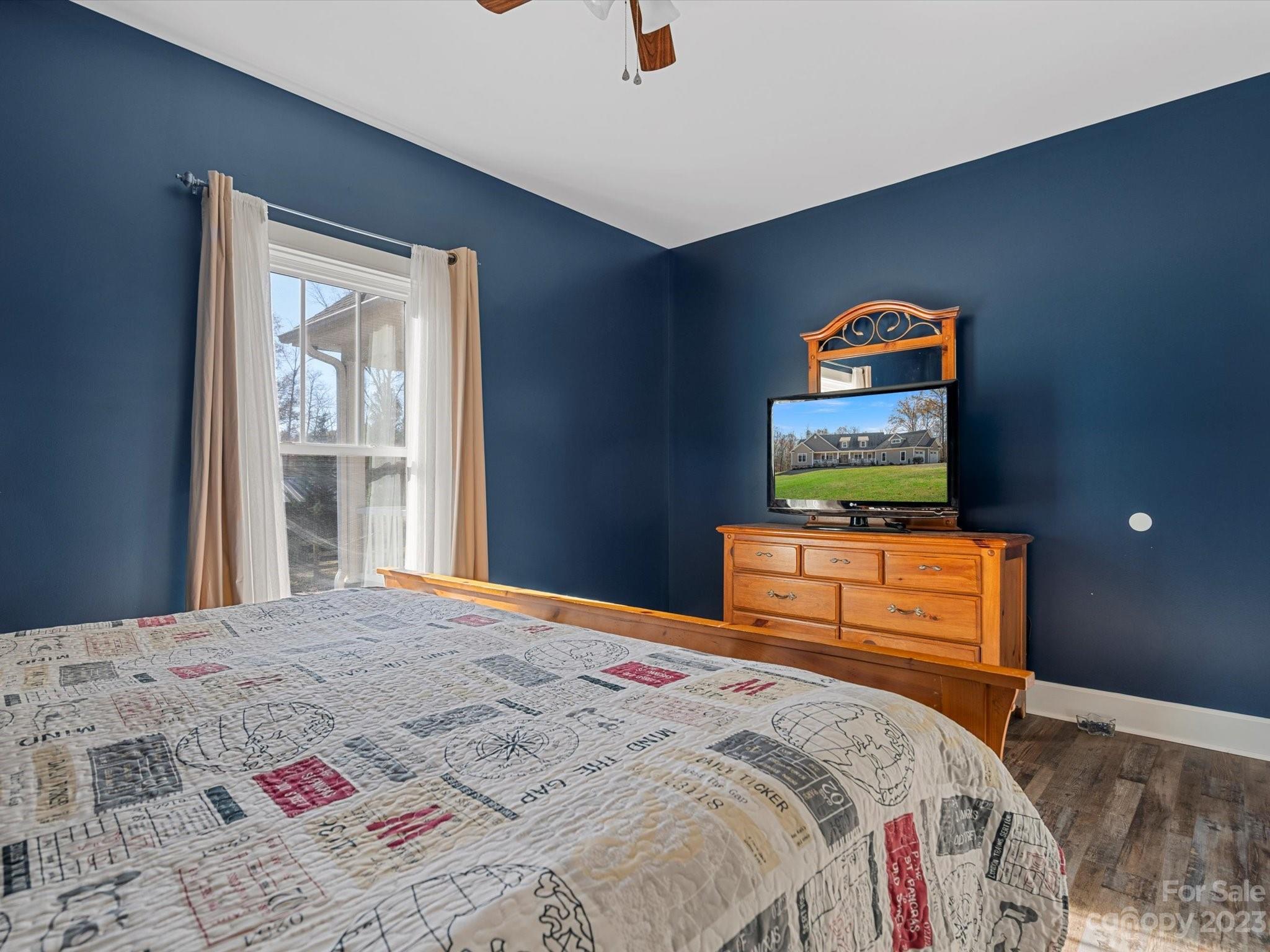 810 Sutton Spring Road York, SC 29745 - Photo 19 of 47 a bedroom with a bed and a flat screen tv