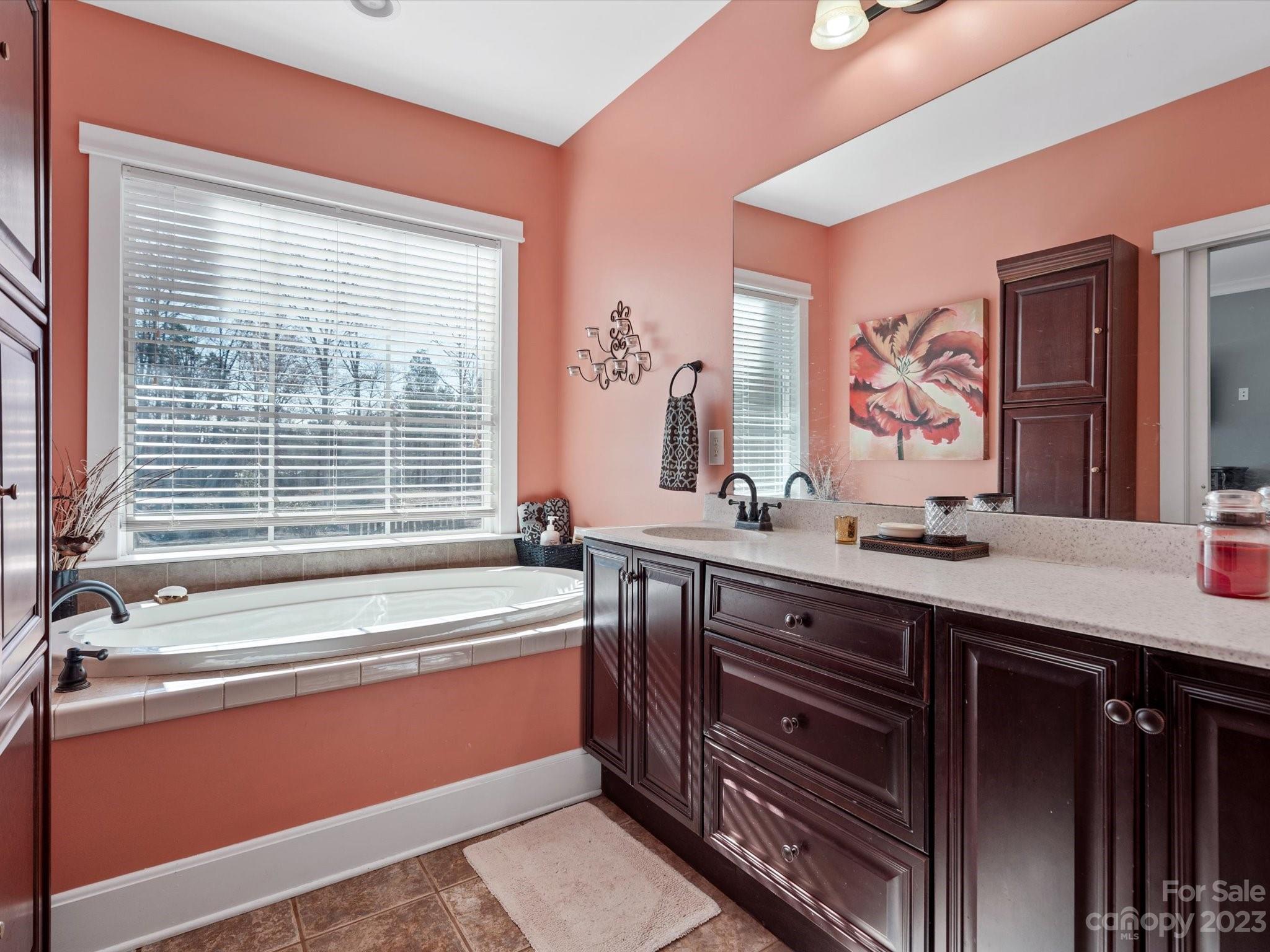 810 Sutton Spring Road York, SC 29745 - Photo 23 of 47 a spacious bathroom with a granite countertop tub sink and mirror