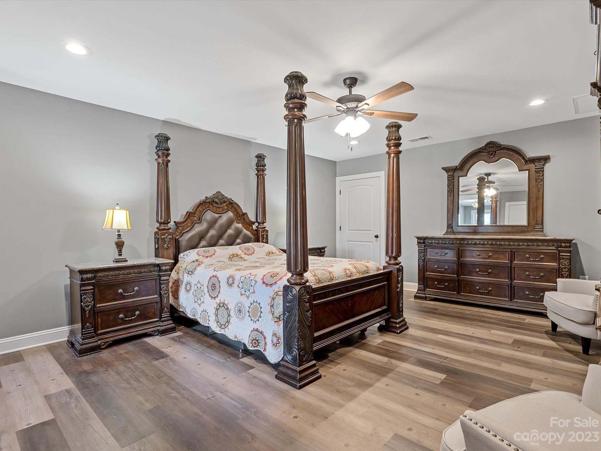 810 Sutton Spring Road York, SC 29745 - Photo 39 of 47 a bedroom with a bed and a chandelier