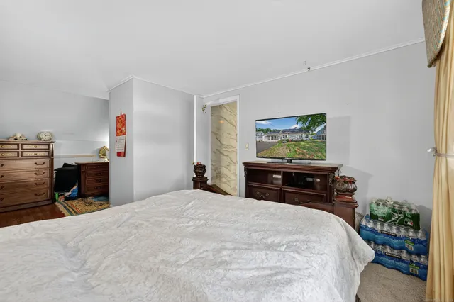 a bedroom with a bed and a chandelier