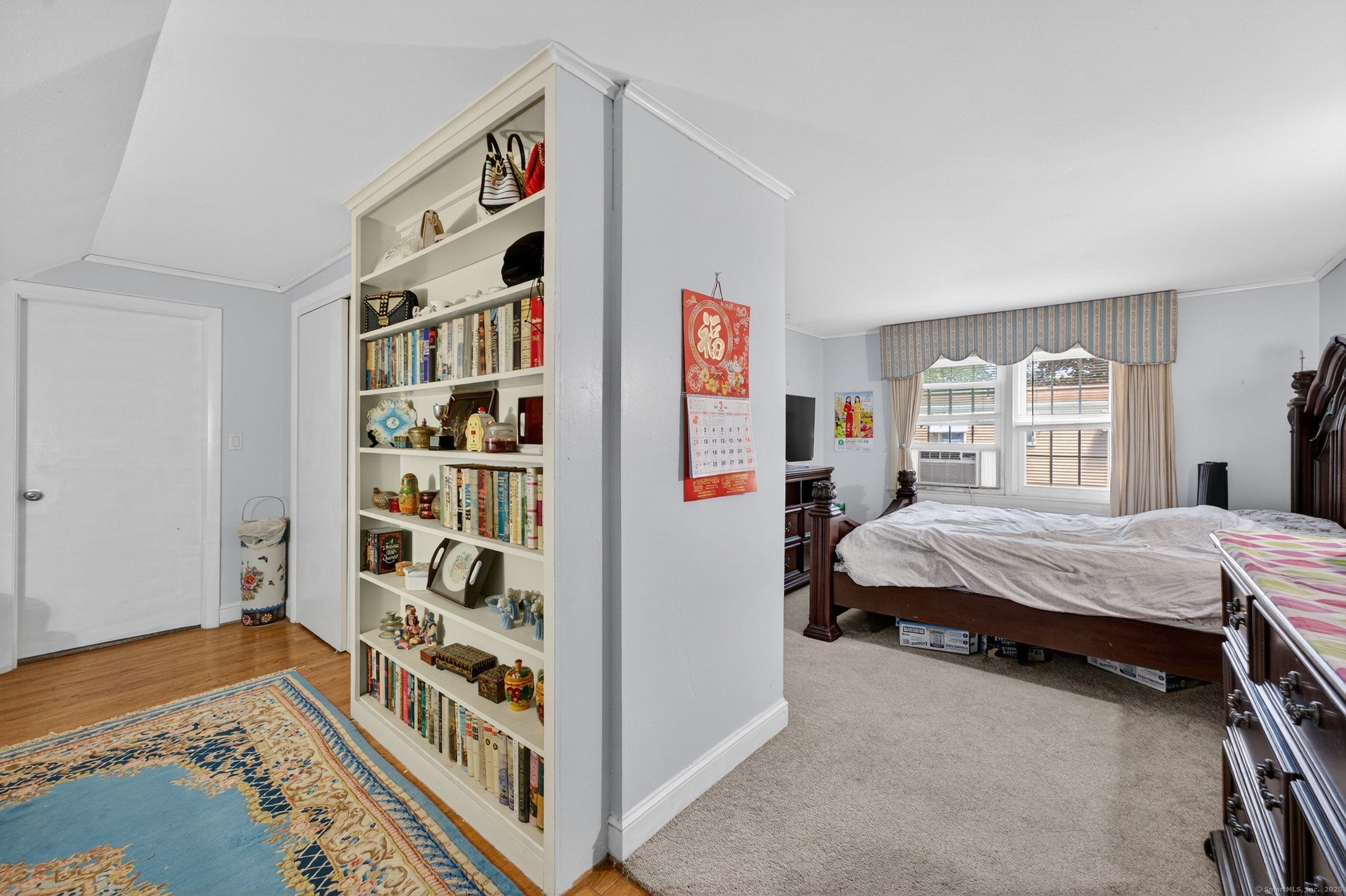 15 St John Street Manchester, CT 06040 - Photo 23 of 36 a bedroom with a bed and a bookshelf