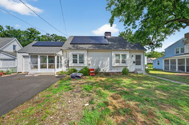 a view of a house with backyard sitting area and garden