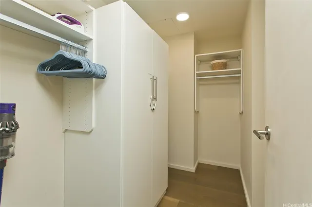 a view of a hallway with a cabinet and door