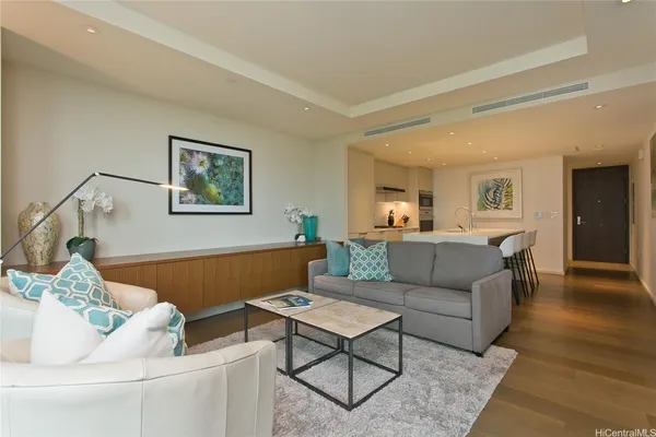 a living room with furniture and a wooden floor