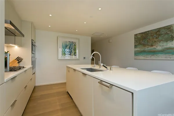 a kitchen with a sink and a stove top oven