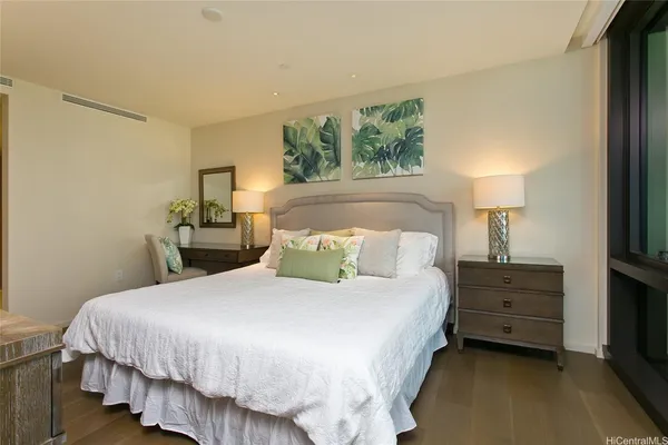 a bedroom with a bed and a night stand