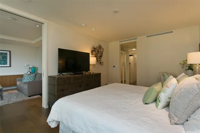 a bedroom with a bed and a flat screen tv