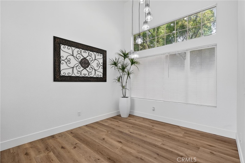 21484 Dickinson Road Moreno Valley, CA 92557 - Photo 12 of 48 a view of empty room with wooden floor and fan