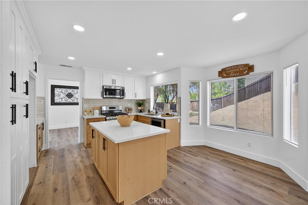 21484 Dickinson Road Moreno Valley, CA 92557 - Photo 14 of 48 a kitchen with stainless steel appliances granite countertop a sink stove and a refrigerator