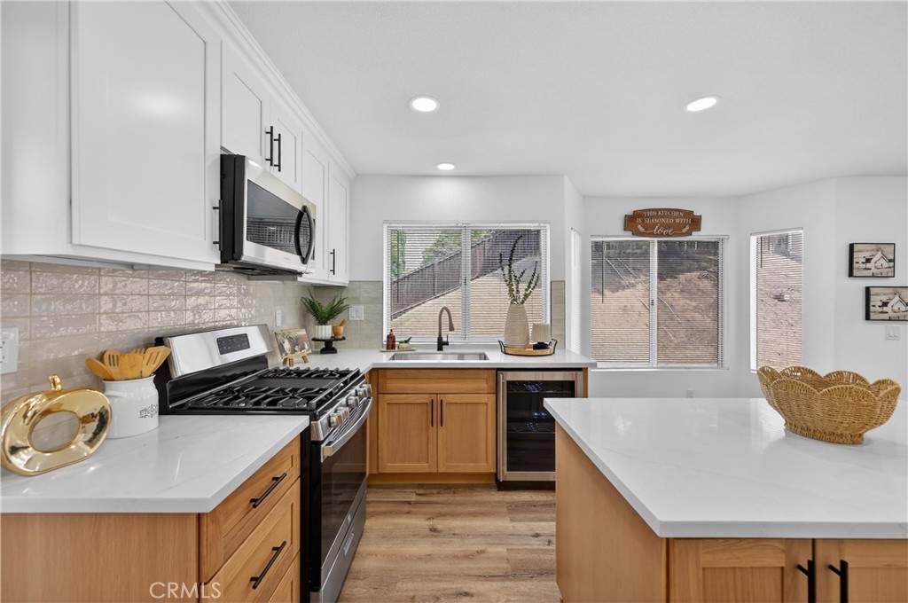 21484 Dickinson Road Moreno Valley, CA 92557 - Photo 16 of 48 a kitchen with stainless steel appliances granite countertop a stove a sink and a microwave
