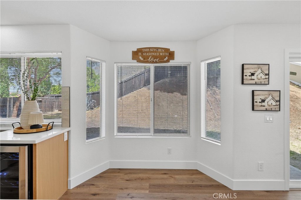 21484 Dickinson Road Moreno Valley, CA 92557 - Photo 18 of 48 a view of an empty room with wooden floor and a window