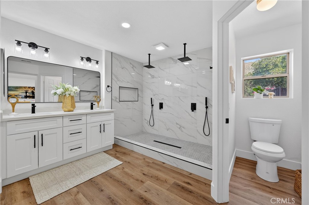 21484 Dickinson Road Moreno Valley, CA 92557 - Photo 28 of 48 a spacious bathroom with a granite countertop sink mirror and toilet