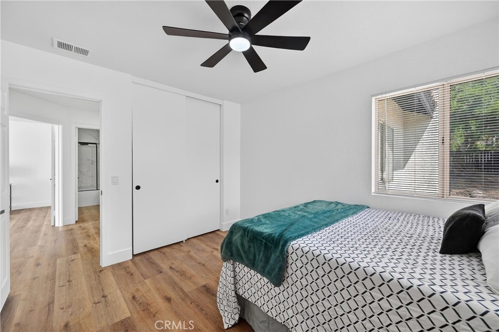 21484 Dickinson Road Moreno Valley, CA 92557 - Photo 35 of 48 a bedroom with a bed and a large window