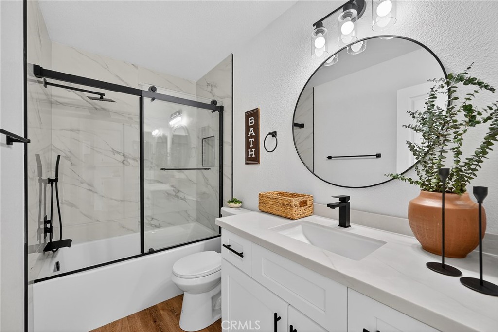 21484 Dickinson Road Moreno Valley, CA 92557 - Photo 36 of 48 a bathroom with a sink mirror toilet and shower