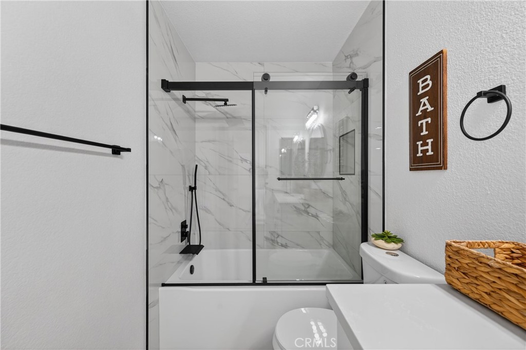 21484 Dickinson Road Moreno Valley, CA 92557 - Photo 37 of 48 a bathroom with a shower a toilet and a sink
